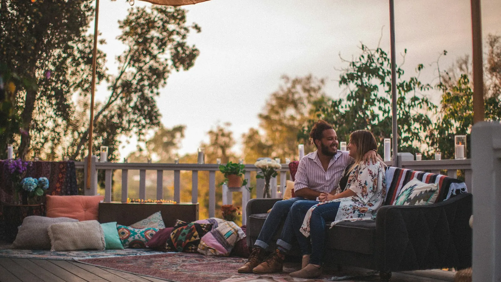 A TV spot for an outdoor furniture brand: a couple relaxing on a lit patio