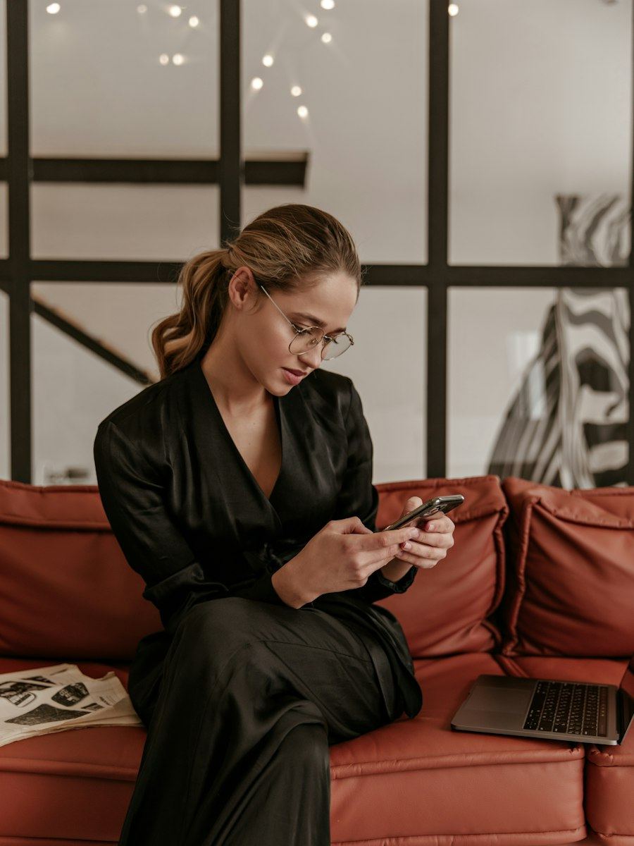A shopper browsing a store on her phone from the couch
