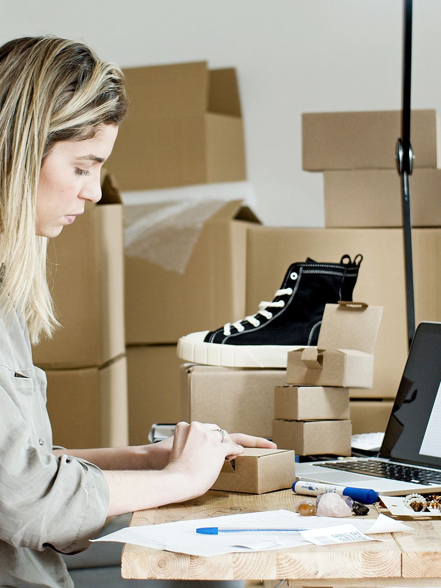 A small business owner packing online orders