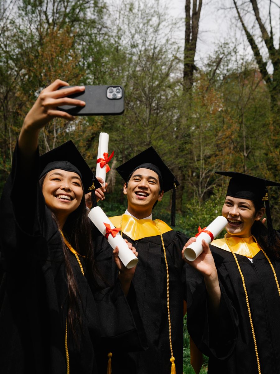 Graduates celebrating with their diplomas