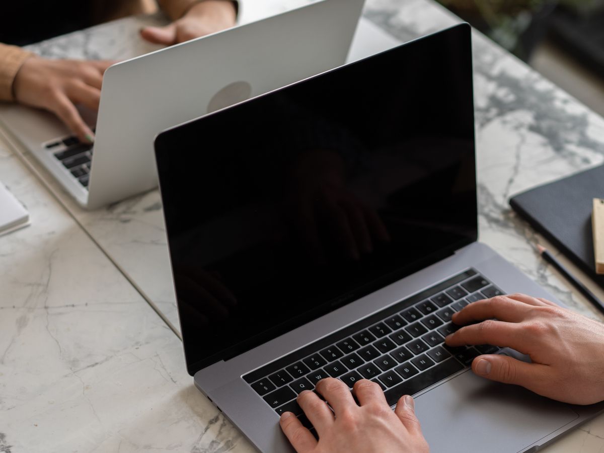 An admissions team reviewing results on a laptop