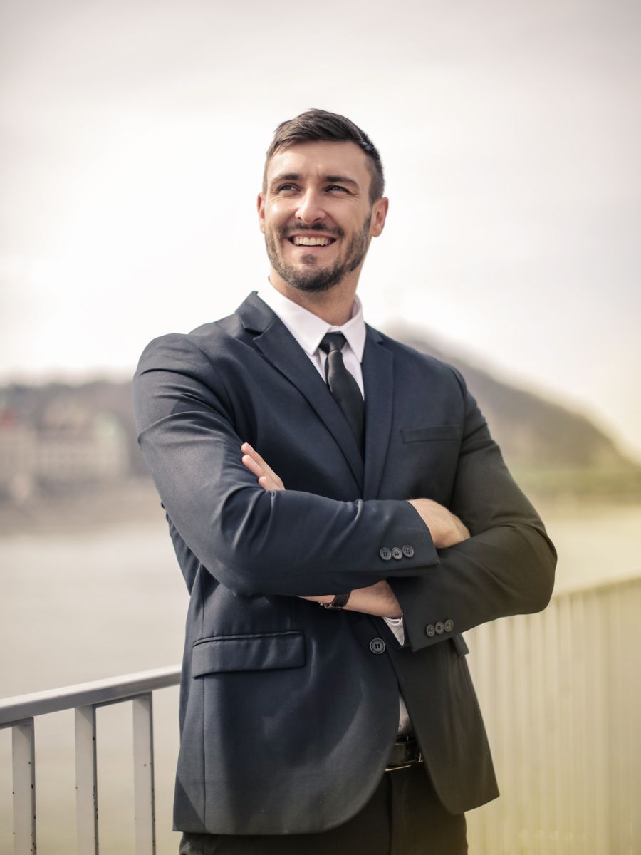 A financial advisor smiling in a suit and tie