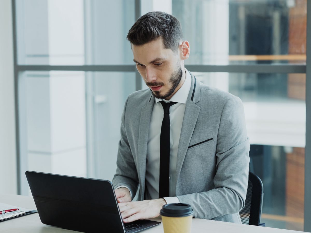 An attorney reviewing performance on a laptop