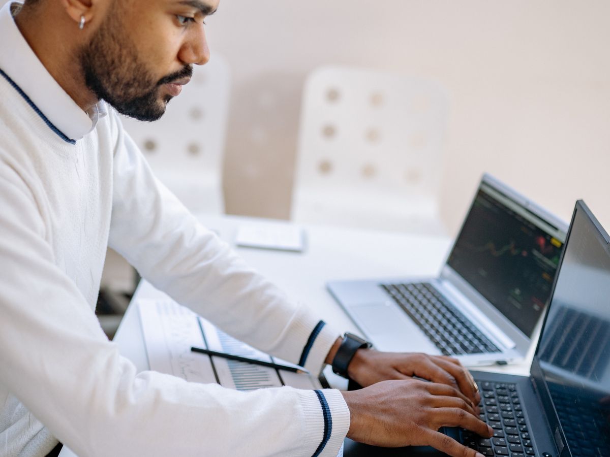 A practice manager reviewing results on a laptop