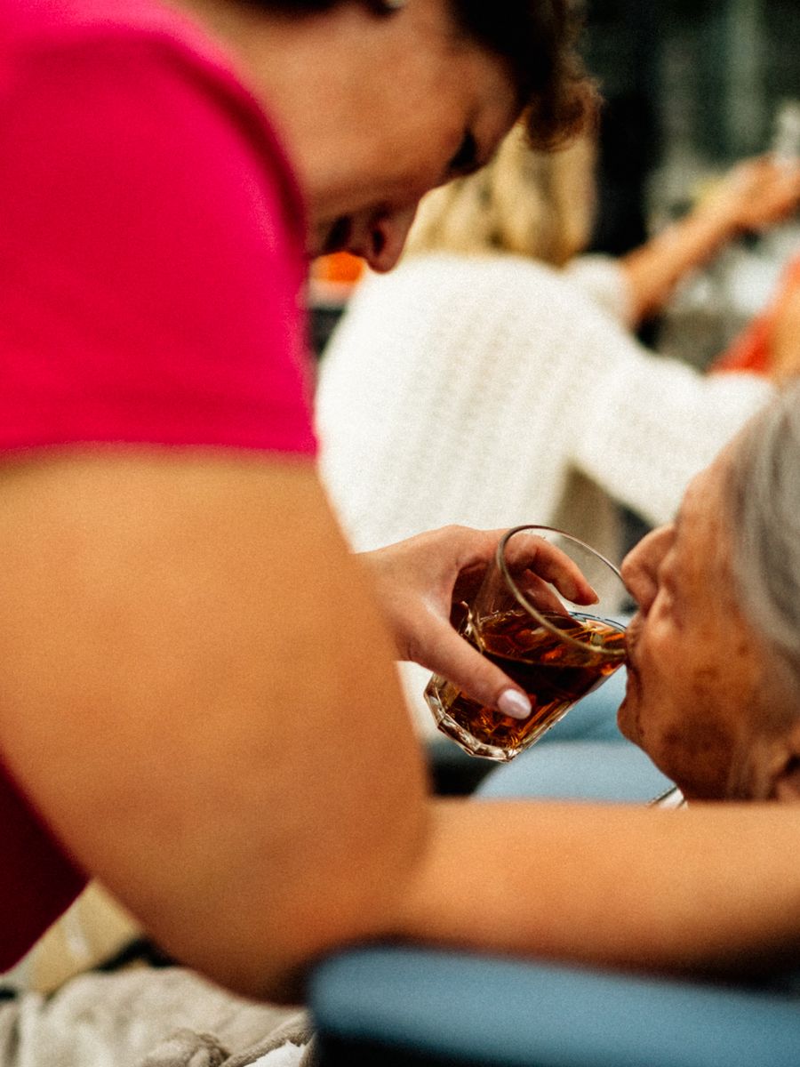A caregiver helping an elderly woman at home