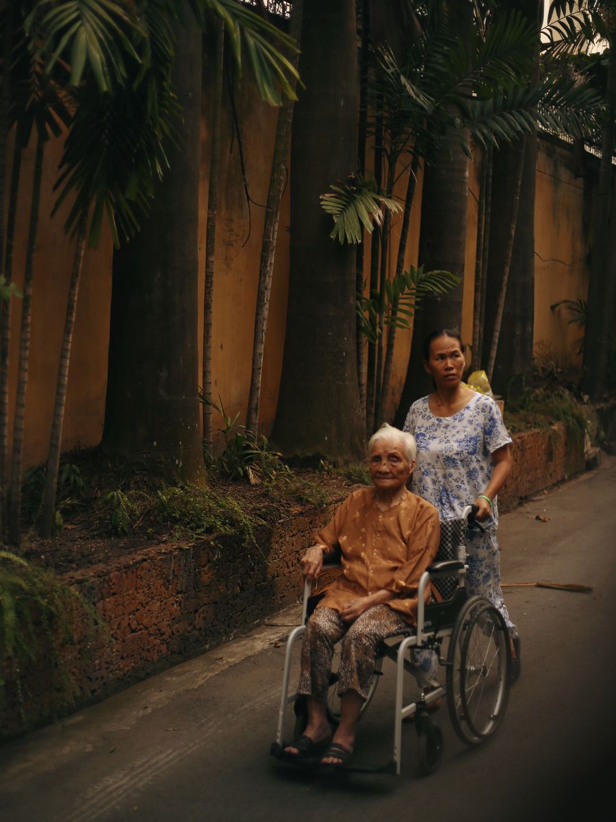 A caregiver assisting a senior outdoors