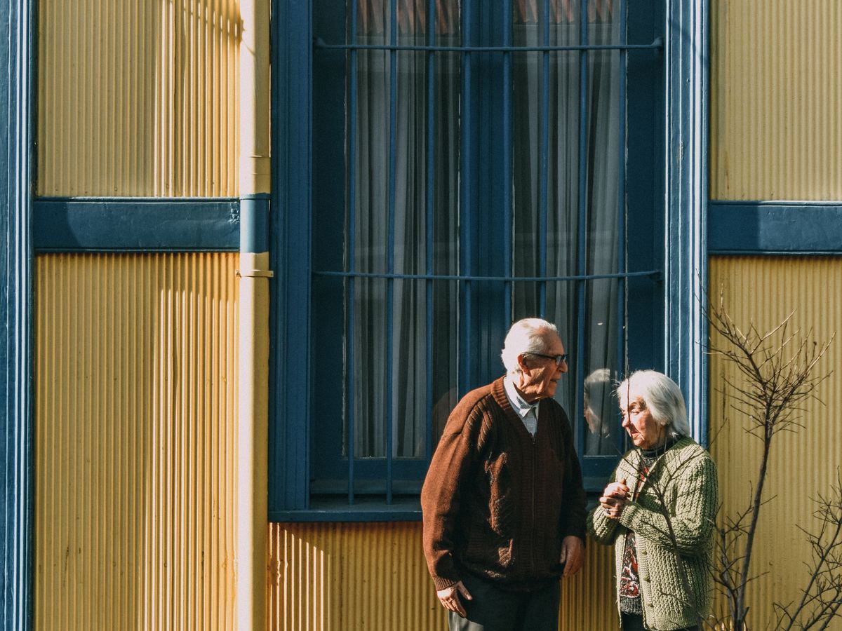 A senior couple outside a care community