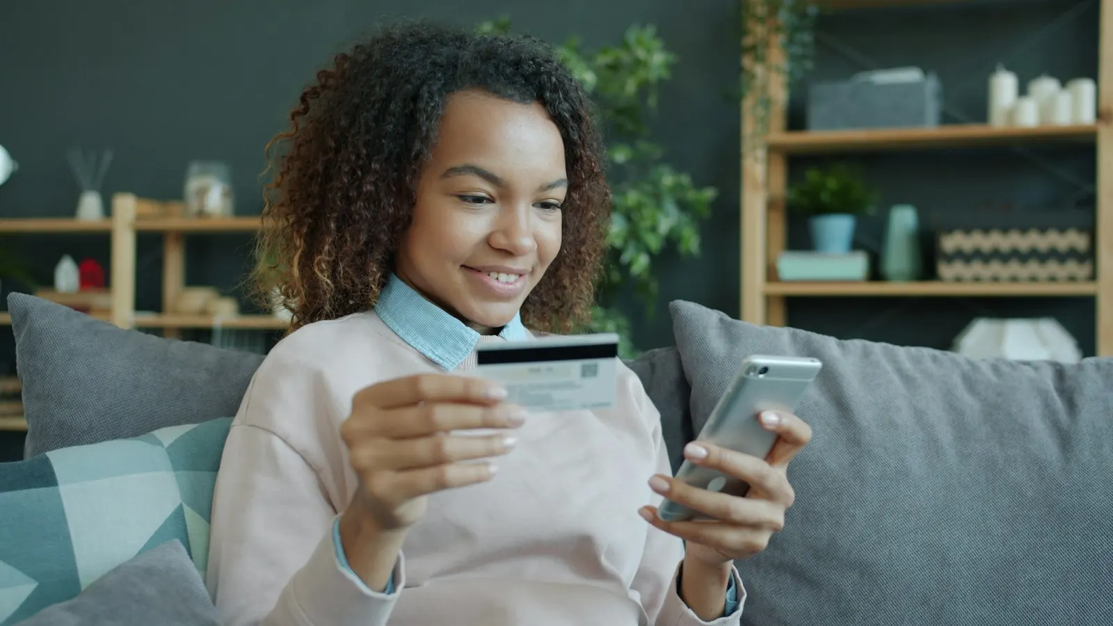 A shopper paying on her phone from the couch